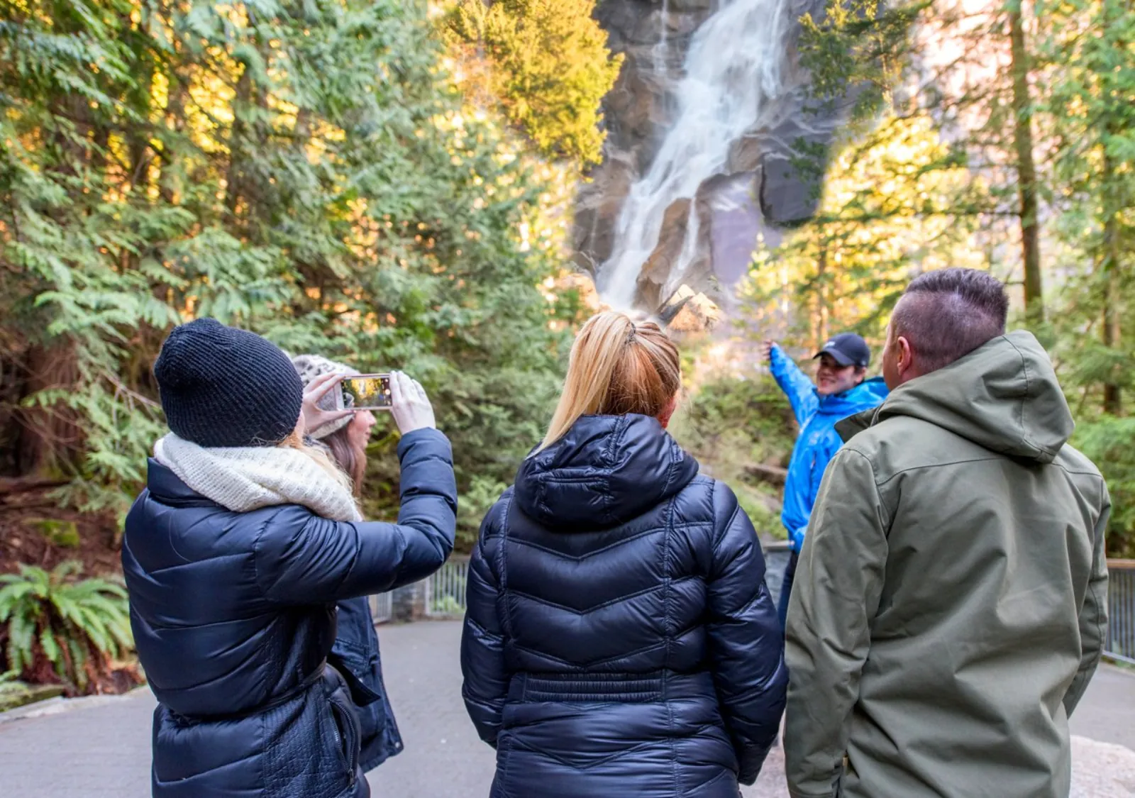 Landsea guide pointing out Shannon Falls to a group of guests in winter jackets