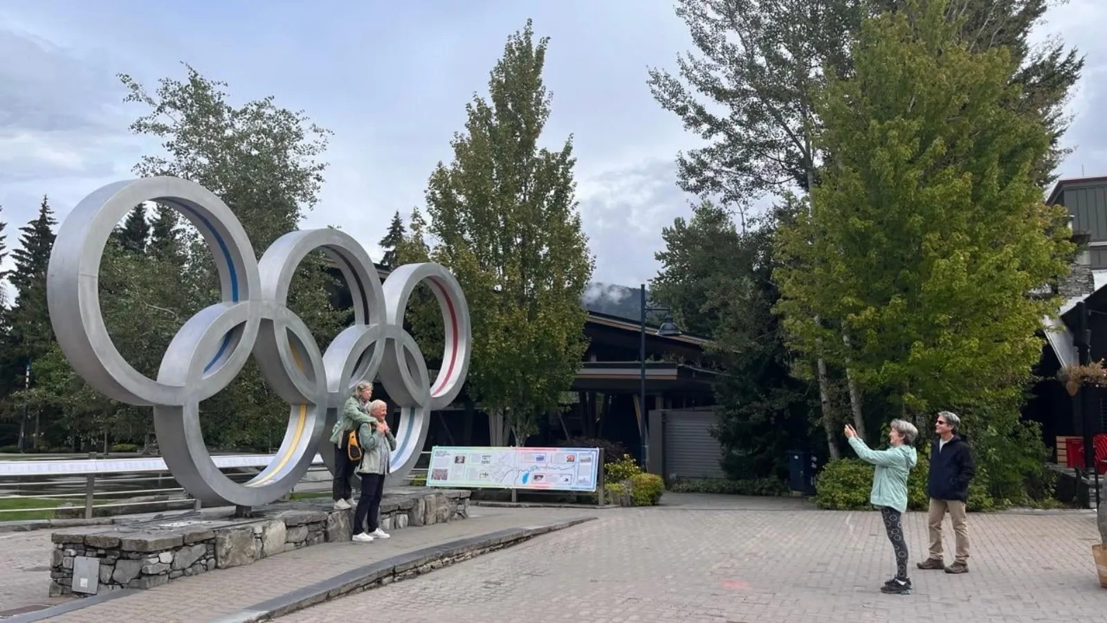 Visitors taking photos at the Olympic rings in Whistler Village